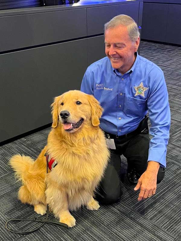 Collier County Sheriff Kevin Rambosk and Golden PAWS Ambassador Dog