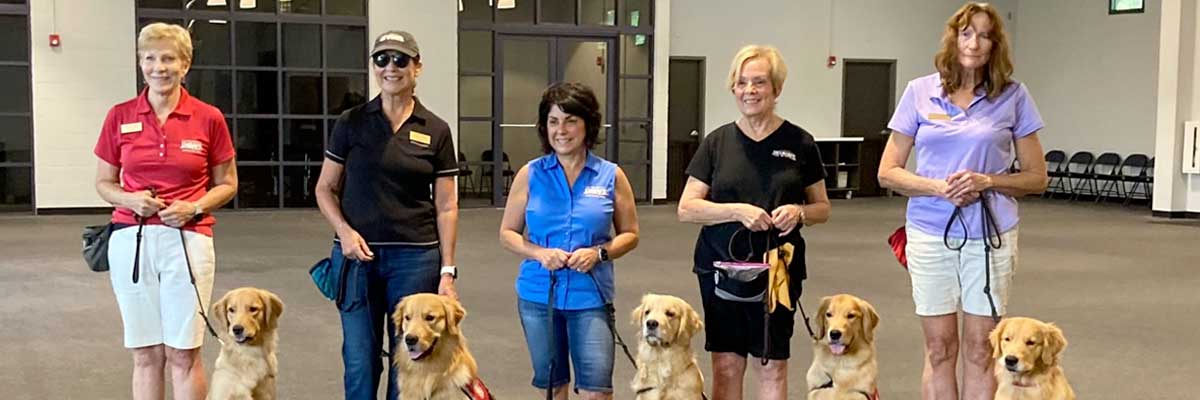 Group of Golden PAWS expert dog trainers at a demonstration presentation
